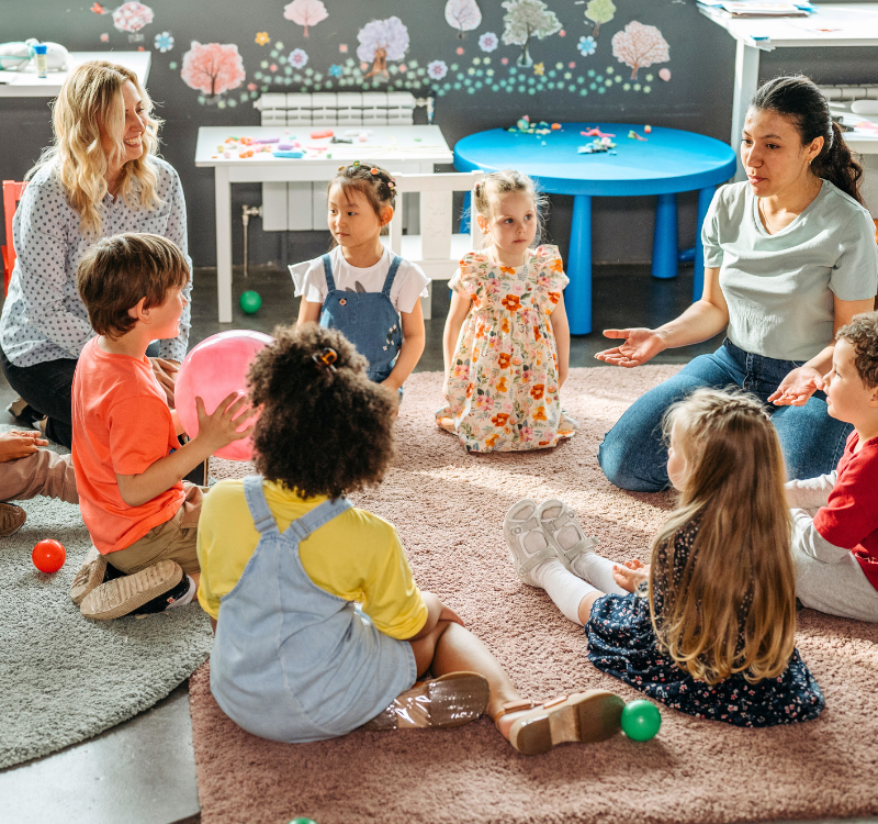 Young children sit in a circle
