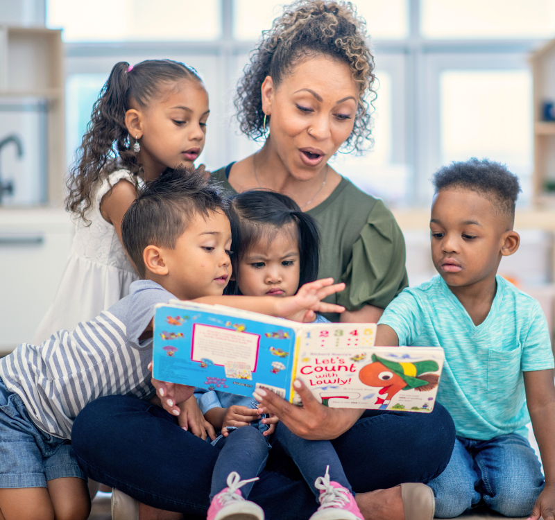 Women reads books to young children