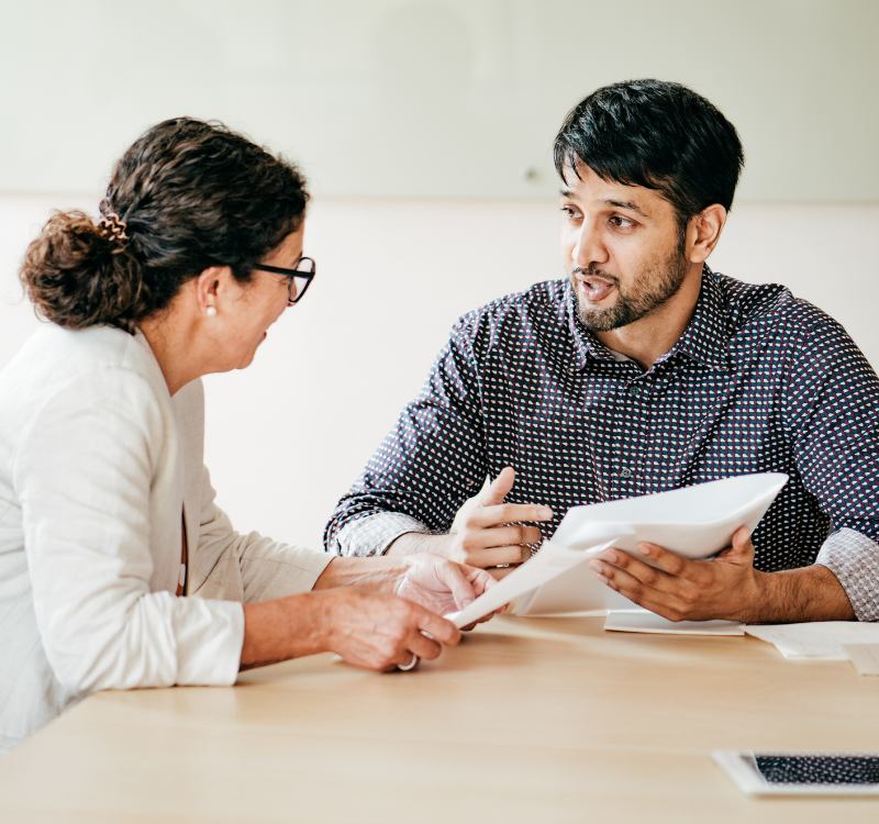 Man and woman chatting at a table