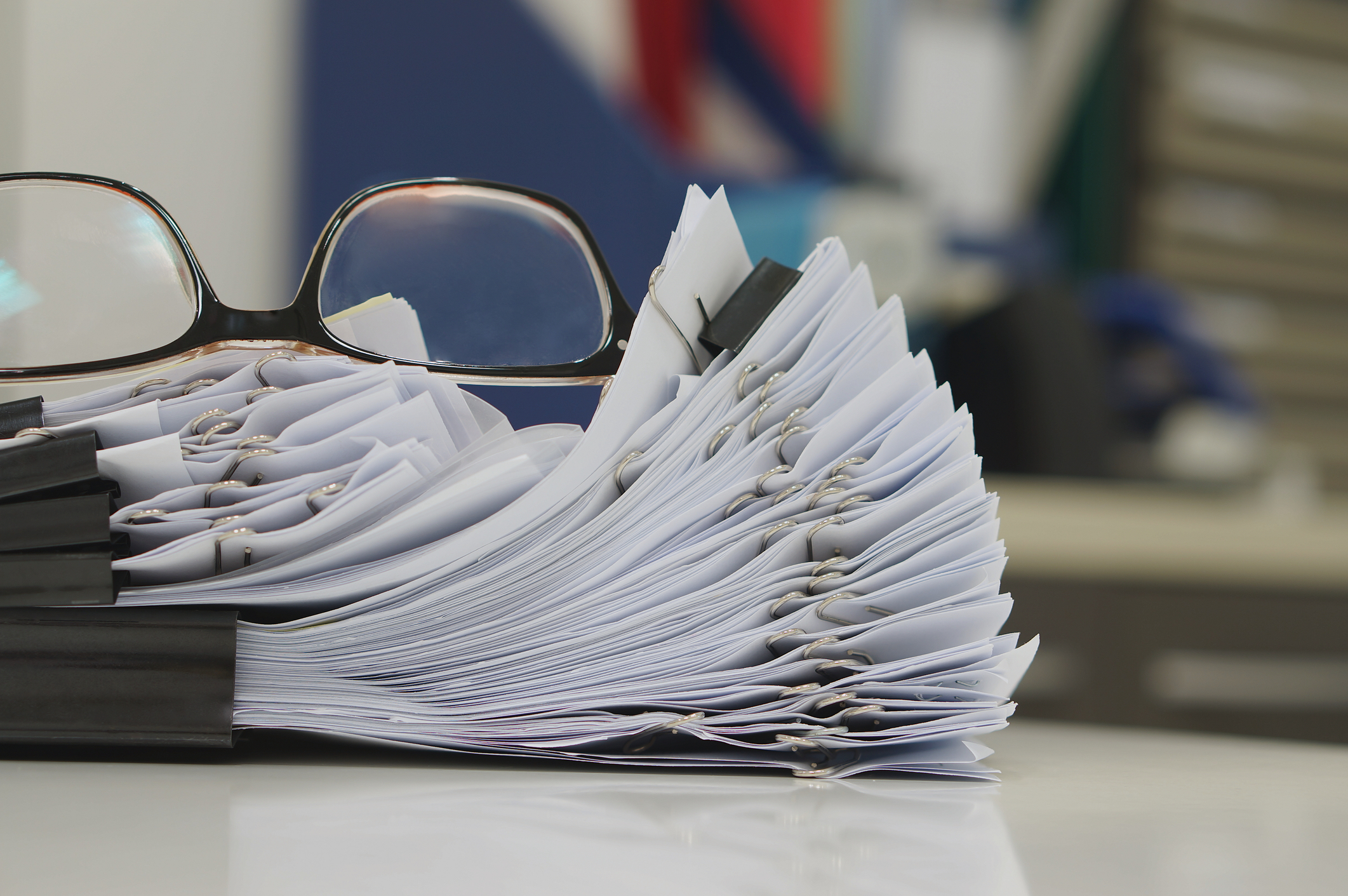 Stack of papers with glasses